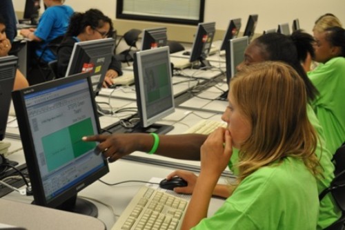 Green campers working on their web pages